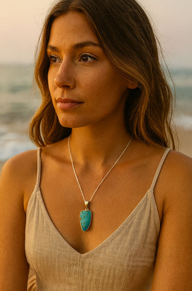 Woman wearing a necklace with a turquoise pendant by the ocean Natural turquoise stone cabochon pendant jewellery